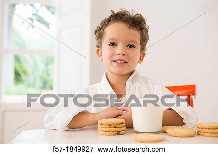 Four year old boy with milk and cookies for breakfast View Large Photo Image Stock Photo - Four year old boy with milk and cookies for breakfast. Fotosearch