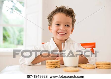 Four year old boy with milk and cookies for breakfast View Large Photo Image Stock Photo - Four year old boy with milk and cookies for breakfast. Fotosearch