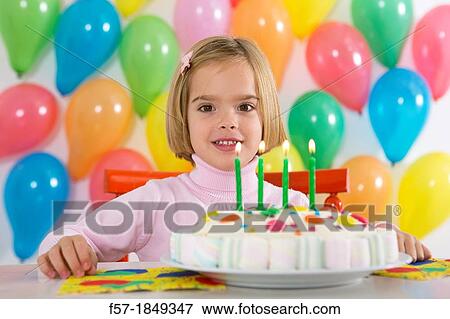 Four year old girl celebrating her birthday View Large Photo Image Stock Photo - Four year old girl celebrating her birthday. Fotosearch