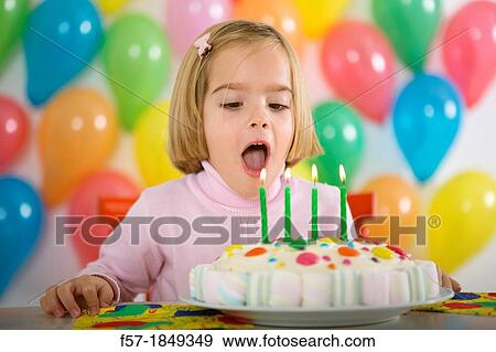 Four year old girl celebrating her birthday View Large Photo Image Stock Photo - Four year old girl celebrating her birthday. Fotosearch