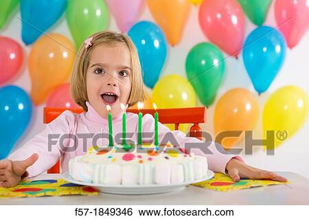 Four year old girl celebrating her birthday View Large Photo Image Stock Photograph - Four year old girl celebrating her birthday. Fotosearch