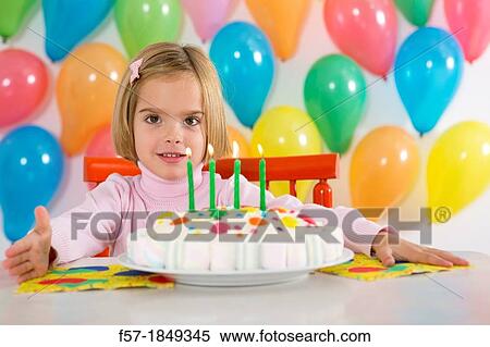 Stock Photography - Four year old girl celebrating her birthday. Fotosearch