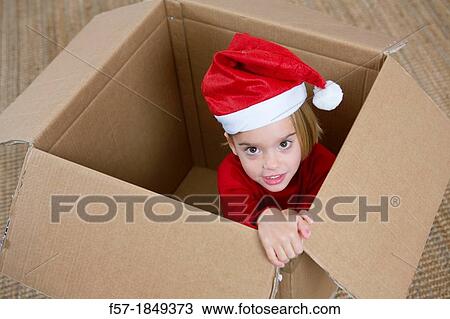 Four year old girl playing in a cardboard box at Christmas View Large Photo Image Stock Image - Four year old girl playing in a cardboard box at Christmas. Fotosearch