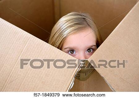 Four year old girl playing in a cardboard box View Large Photo Image Stock Photo - Four year old girl playing in a cardboard box. Fotosearch