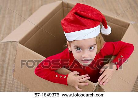 Four year old girl playing in a cardboard box at Christmas View Large Photo Image Stock Photograph - Four year old girl playing in a cardboard box at Christmas. Fotosearch