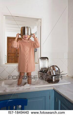 Four year old girl playing in the kitchen sink View Large Photo Image Stock Image - Four year old girl playing in the kitchen sink. Fotosearch