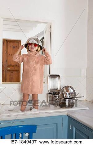 Four year old girl playing in the kitchen sink View Large Photo Image Stock Photo - Four year old girl playing in the kitchen sink. Fotosearch