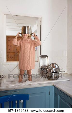 Four year old girl playing in the kitchen sink View Large Photo Image Stock Photo - Four year old girl playing in the kitchen sink. Fotosearch