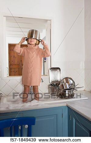 Four year old girl playing in the kitchen sink View Large Photo Image Stock Photo - Four year old girl playing in the kitchen sink. Fotosearch