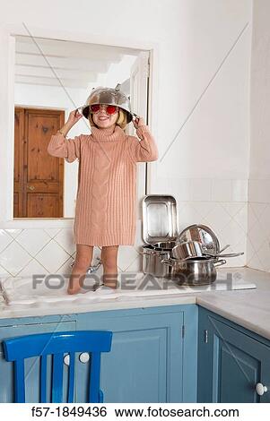 Four year old girl playing in the kitchen sink View Large Photo Image Stock Photograph - Four year old girl playing in the kitchen sink. Fotosearch