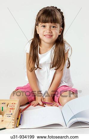 Four year old girl smiling at the camera ready to do homework View Large Photo Image Stock Photo - Four year old girl smiling at the camera ready to do homework. Fotosearch