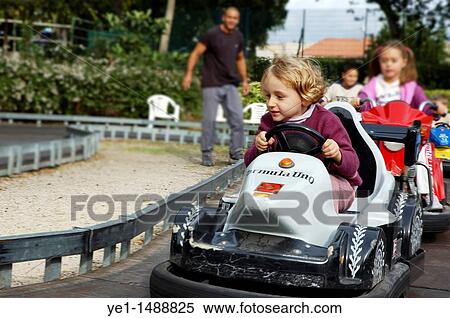 Four year old girl speeding in a go kart at an amusement park. View Large Photo Image Stock Photography - Four year old girl speeding in a go kart at an amusement park.. Fotosearch