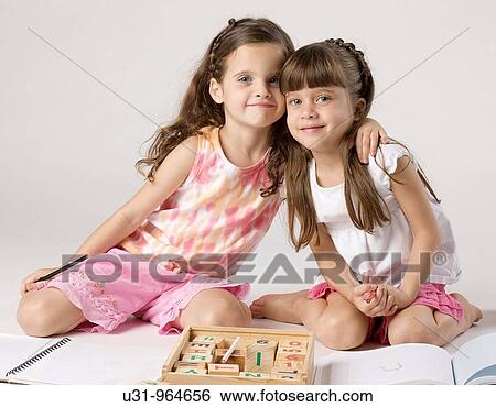 Four year old twins hugging and smiling at the camera View Large Photo Image Stock Photograph - Four year old twins hugging and smiling at the camera. Fotosearch