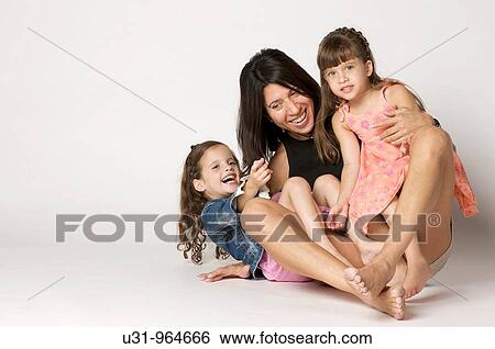 Four year old twins sitting and playing in their mother's lap View Large Photo Image Stock Photograph - Four year old twins sitting and playing in their mother's lap. Fotosearch