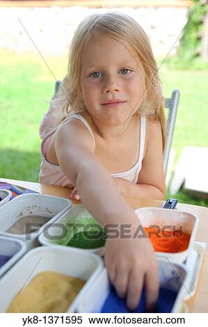 Stock Photography - Four Year Old Young Kid Girl Working with Color Sand in Art Class. Fotosearch