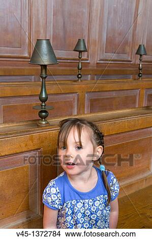 Picture - Four years old girl in a church.. Fotosearch
