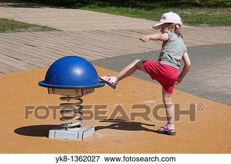 Four Years Old Girl Kicking Swing at Playground View Large Photo Image Stock Photo - Four Years Old Girl Kicking Swing at Playground. Fotosearch