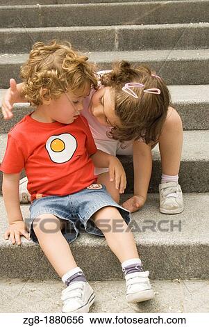Four years-old girl taking care of her little brother View Large Photo Image Stock Photograph - Four years-old girl taking care of her little brother. Fotosearch