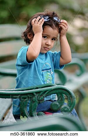 Four years old Indian baby girl on a bench, Darjeeling. India. View Large Photo Image Stock Image - Four years old Indian baby girl on a bench, Darjeeling. India.. Fotosearch