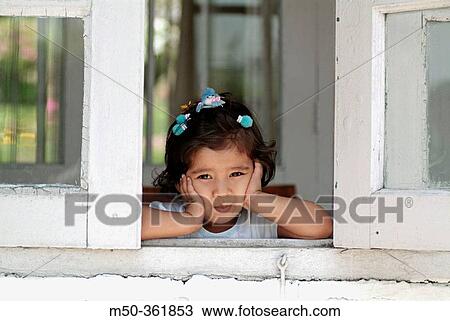Four years old Indian baby girl through a window. India. View Large Photo Image Stock Image - Four years old Indian baby girl through a window. India.. Fotosearch