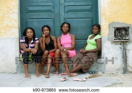 Four young African ladies sitting at a door entrance, Ilha de Mocambique (Island of Mozambique), Mozambique, Southern Africa View Large Photo Image Stock Photography - Four young African ladies sitting at a door entrance, Ilha de Mocambique (Island of Mozambique), Mozambique, Southern Africa. Fotosearch