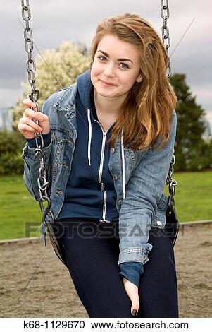 Stock Image - Fourteen year old girl in a playground in Vancouver, BC, Canada. Fotosearch