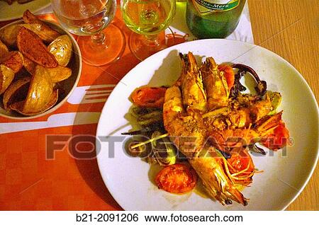 France. Aquitaine. Gironde. Food: "Gambas au saut? de legumes" ( shrimps with fresh saut? of vegetables), with "Entre Deux Mers" white wine from Bordeaux area. View Large Photo Image Stock Photograph - France. Aquitaine. Gironde. Food: "Gambas au saut? de legumes" ( shrimps with fresh saut? of vegetables), with "Entre Deux Mers" white wine from Bordeaux area.. Fotosearch