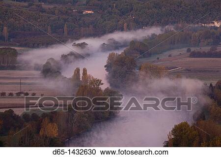 France, Aquitaine Region, Dordogne Department, Domme, elevated view of the Dordogne River Valley in fog from the Belvedere de la Barre, dawn View Large Photo Image Stock Image - France, Aquitaine Region, Dordogne Department, Domme, elevated view of the Dordogne River Valley in fog from the Belvedere de la Barre, dawn. Fotosearch