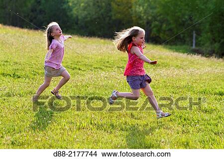 France, Bas Rhin, Urbeis near the Climont, girls in a meadow. View Large Photo Image Picture - France, Bas Rhin, Urbeis near the Climont, girls in a meadow.. Fotosearch