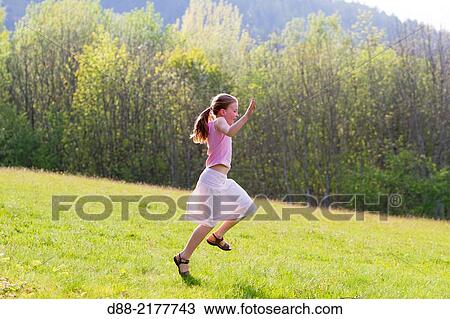Stock Image - France, Bas Rhin, Urbeis near the Climont, girl in a meadow.. Fotosearch