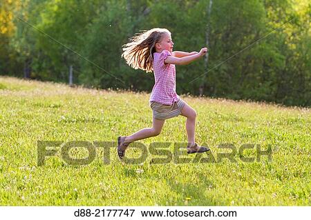 France, Bas Rhin, Urbeis near the Climont, girl in a meadow. View Large Photo Image Stock Photo - France, Bas Rhin, Urbeis near the Climont, girl in a meadow.. Fotosearch