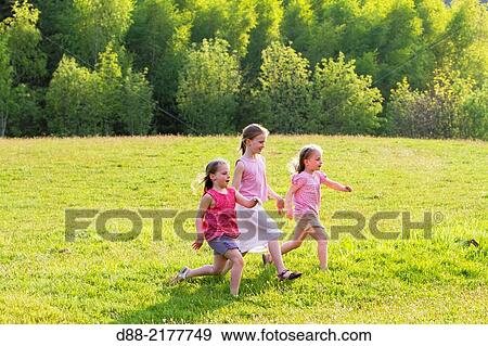 France, Bas Rhin, Urbeis near the Climont, girls in a meadow. View Large Photo Image Stock Photo - France, Bas Rhin, Urbeis near the Climont, girls in a meadow.. Fotosearch