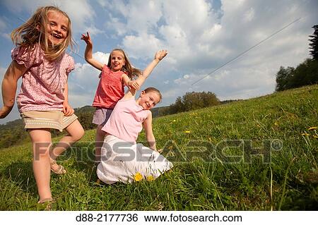 France, Bas Rhin, Urbeis near the Climont, girls in a meadow. View Large Photo Image Stock Photograph - France, Bas Rhin, Urbeis near the Climont, girls in a meadow.. Fotosearch