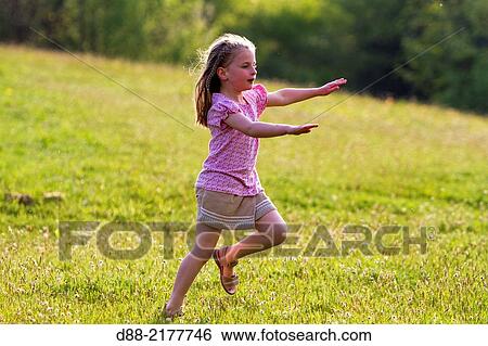France, Bas Rhin, Urbeis near the Climont, girl in a meadow. View Large Photo Image Stock Photograph - France, Bas Rhin, Urbeis near the Climont, girl in a meadow.. Fotosearch