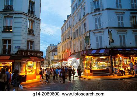 Stock Image - France, Europe, French, Paris, 18th arrondissement, Montmatre, Place Saint St. Pierre, Rue de Steinkerque, night, nightlife, shopping, Haussmann apartment buildings,.. Fotosearch