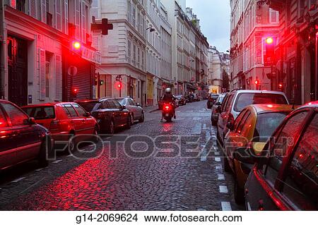Picture - France, Europe, French, Paris, 9th arrondissement, Saint St. Georges, Rue de la Rochefoucauld, street, dusk, Haussmann apartment buildings, red traffic light,.. Fotosearch