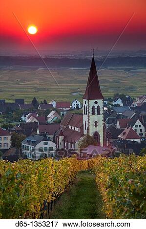 Stock Photo - France, Haut-Rhin, Alsace Region, Alasatian Wine Route, Ammerschwihr, town view, sunrise, autumn. Fotosearch