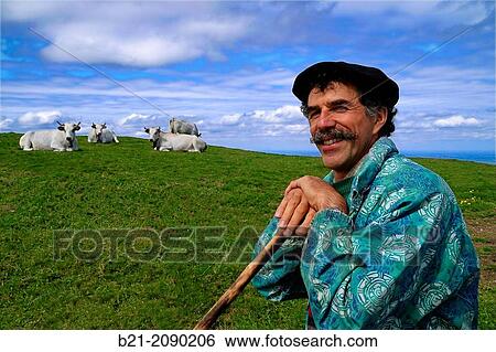 Stock Photograph - France. Midi Pyr? n? es-Ari? ge. Apaciale. Eleveur Christian Laguerre, from "Groupement Pastoral Prat d? Albis" at "Plat d? Albis", over Foix.. Fotosearch