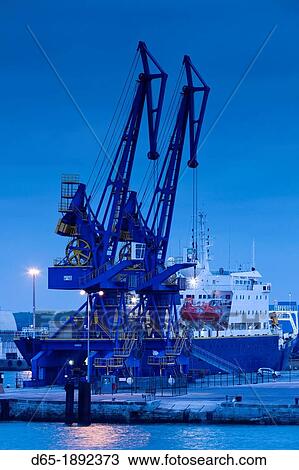 Stock Image - France, Nord-Pas de Calais Region, Pas de Calais Department, Calais, port view, dusk. Fotosearch