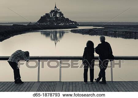 France, Normandy Region, Manche Department, Mont St-Michel, Le Barrage du Mont Saint Michel dam, dusk, silhouettes of people, NR View Large Photo Image Stock Image - France, Normandy Region, Manche Department, Mont St-Michel, Le Barrage du Mont Saint Michel dam, dusk, silhouettes of people, NR. Fotosearch