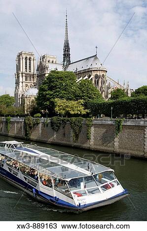 Stock Image - France, Paris 75 Notre Dame cathedral and tourist boat on the Seine river. Fotosearch