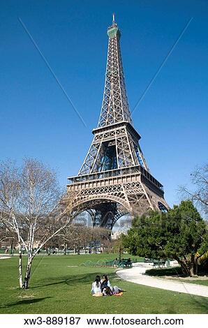Stock Photo - France, Paris 75 People on the grass beside Eiffel tower. Fotosearch