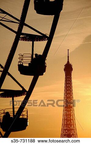 France. Paris. The view of the ferry wheel in Palace de la Concorde with Eiffel Tower in the background after sun set. View Large Photo Image Stock Photo - France. Paris. The view of the ferry wheel in Palace de la Concorde with Eiffel Tower in the background after sun set.. Fotosearch