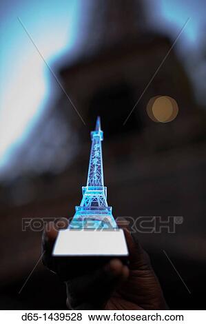 Stock Photo - France, Paris, toy Eiffel Tower in front of the real one. Fotosearch