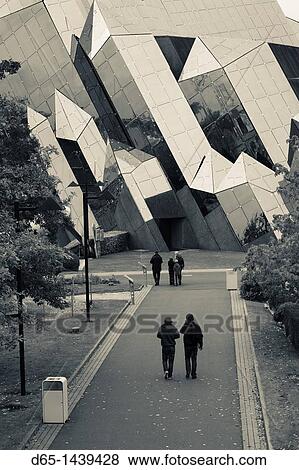 Stock Photo - France, Poitou-Charentes Region, Vienne Department, Poitiers, Futuroscope Science Park, park visitors by IMAX theater. Fotosearch