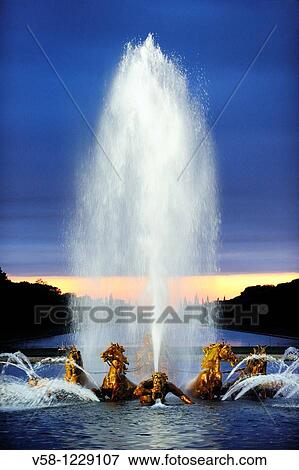 Stock Photo - France, Yvelines, World Heritage Site, Gardens of the Chateau de Versailles, Bassin d? Apollon, Fountains Night Show? Les Grandes Eaux Nocturnes?. Fotosearch
