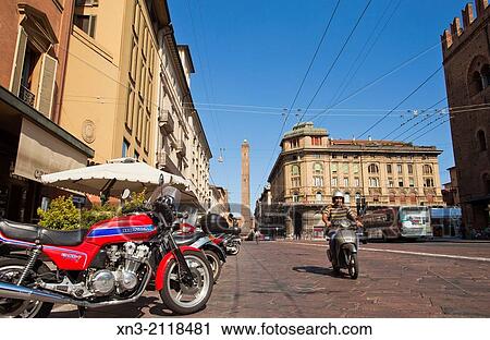 Stock Image - Francesco Rizzoli street on background Asinelli tower, Two Towers symbol of Bologna in Porta Ravegnana Square, Bologna, Emilia-Romagna, Italy, Europe.. Fotosearch