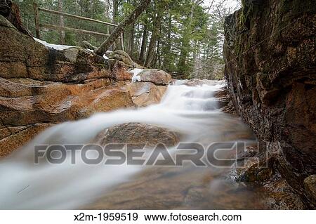 Stock Photo - Franconia Notch State Park - The Baby Flume, which is located just below "The Basin" viewing area along the Pemigewasset River in Lincoln, New Hampshire USA during the spring months.. Fotosearch