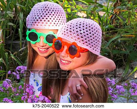 Fraternal twins in garden of flowers View Large Photo Image Stock Image - Fraternal twins in garden of flowers. Fotosearch