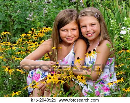 Stock Photography - Fraternal twins in garden of flowers. Fotosearch